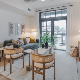a living room with chairs and a couch