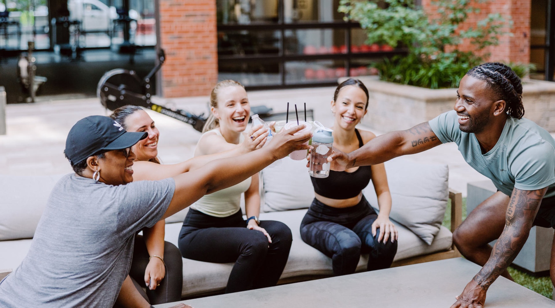 people outside holding up drinks